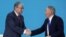 Kazakhstan's President Tokayev shakes hands with former President Nazarbayev at a congress of the Nur Otan ruling party in Nur-Sultan