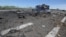 Ukraine -- A destroyed armored vehicle is seen on the road of the airport in the south of Luhansk, July 14, 2014