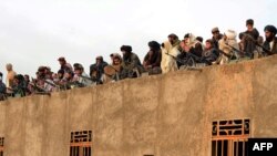 FILE: Taliban fighters in the western province of Farah