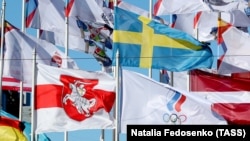 The red-and-white Belarusian flag (lower left) is seen flying in Riga outside the Radisson Blu Hotel, where players are staying.