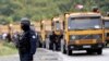 KOSOVO -- A Kosovo special police officer stands near trucks where Kosovo Serbs block a road near the northern Kosovo border crossing of Jarinje, September 20, 2021