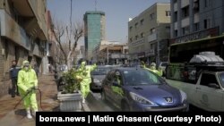 Workers in Iran disinfect streets in central Tehran against the novel coronavirus.