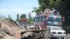 A convoy of local residents travels past wreckage as they flee the area of military operations against Taliban militants in the Naway Kalay area of Swat Valley on May 15.