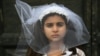 A young actress plays the role of a child bride during a protest organised by Amnesty International to denounce child marriage, on October 27 in Rome.