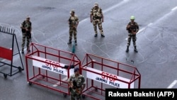 Indian security personnel stand guard at a roadblock in Jammu in Indian-administered Kashmir on August 7.
