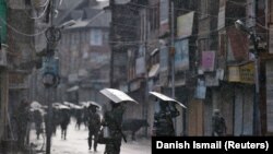 Indian policemen on patrol during restrictions in Srinagar on August 8.