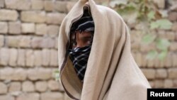 A nineteen-year-old Taliban deserter hides his face in Kunduz Province. “I faced the darkest moment of my life seeing my brother's body covered with blood and dust,” he said.