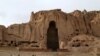 Afghan boys play soccer in front of the empty seat of one of two Buddha statues destroyed by the Taliban in 2001 in Bamiyan Province.