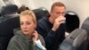 Russian opposition leader Aleksei Navalny and his wife Yulia Navalnaya are seen on board a plane during a flight from Berlin to Moscow on January 17, 2021.