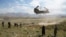 FILE: A U.S. military Chinook helicopter lands on a field outside the governor's palace in Wardak Province in June 2019.