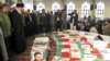 Supreme Leader Ayatollah Ali Khamenei (second from left) and Revolutionary Guards commander Mohammad Ali Jafari (left) stand next to the coffins of 17 members of the Revolutionary Guards who were killed in a blast at a military base last week.