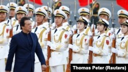 Pakistani Prime Minister Imran Khan reviews the honor guard during a welcome ceremony outside the Great Hall of the People in Beijing on October 8.