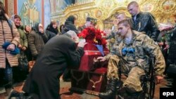 Relatives and friends attend a funeral ceremony of Ukrainian serviceman Ihor Branovytskiy in Kyiv on April 3.