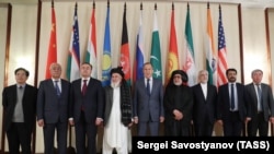  Russian Foreign Minister Sergei Lavrov (center) and members of Taliban delegation pose before the multilateral peace talks on Afghanistan in Moscow