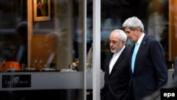 U.S. Secretary of State John Kerry (right) speaks with Iranian Foreign Minister Mohammad Javad Zarif as they walk on a street in Geneva on January 14.