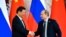 Russian President Vladimir Putin (right) shakes hands with his Chinese counterpart Xi Jinping in Moscow on May 8. 