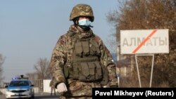 Gazagystanyň harby gullukçylary karantin üçin ýapylan Almaty şäherine girilýän ýerdäki blokpostda.