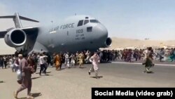 Кабулдагы аэропортто АКШнын аскердик учагынын жолун тосууга аракет кылган ооган жарандар. 16-август, 2021-жыл.