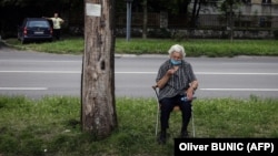 A woman waits for a health check in front of a COVID-19 medical center in Belgrade on July 2.