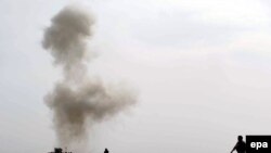 Smoke rises after Afghan Police diffused a land mine in Helmand in February.