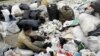 Afghan workers sort through waste plastic in outside Tehran.