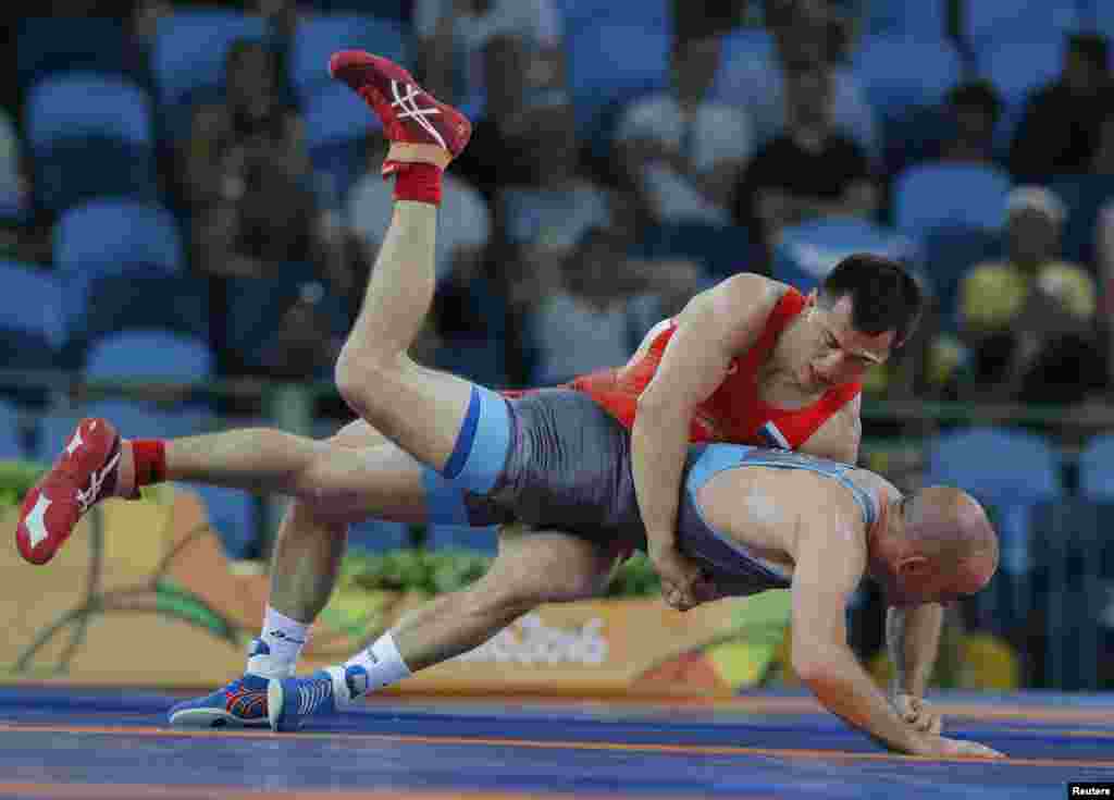 Російський борець Роман Власов (вгорі) виграв золото на другій Олімпіаді поспіль у ваговій категорії до 74 кілограмів у греко-римській боротьбі