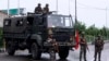 Security personnel stand guard on a street in Jammu on August 5.