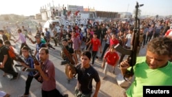 “Ирак менен Леванттагы ислам мамлекети” (ИЛИМ) куралчан тобуна каршы согушка катталган шийилердин кошуундары. Багдад, 15- июнь, 2014.