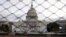 The U.S. Capitol building is seen behind a security fence in Washington on January 19.