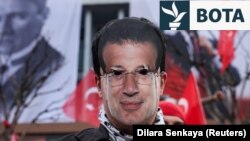 Një burrë mban një maskë me fytyrën e kryebashkiakut të Stambollit, Ekrem Imamoglu, i cili u burgos si pjesë e një hetimi për korrupsion, gjatë një proteste pranë ndërtesës së Bashkisë së Stambollit, në Stamboll, Turqi, më 23 mars 2025.