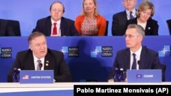 FILE: NATO Secretary-General Jen Stoltenberg, right, looks on as U.S. Secretary of State Mike Pompeo, left, makes opening remarks at the Meeting of the North Atlantic Council in Foreign Ministers' Session 1 at the U.S. State Department in Washington in April.