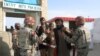 Pakistani soldiers check the identity of citizens returning from Afghanistan at the border crossing in Chaman on March 7.