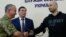 Russian journalist Arkady Babchenko (right) shakes hands with Ukrainian Security Service chief Vasyl Hrytsak (left) as Prosecutor-General Yuriy Lutsenko looks on at a news briefing in Kyiv on May 30.