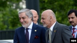 FILE: Afghan President Ashraf Ghani (R) with Chief Executive Abdullah Abdullah (L) in Poland.