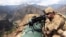 FILE: A U.S. soldier looks through his sniper scope in the province of Kunar in eastern Afghanistan.