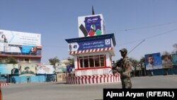 An Afghan soldier stands guard near an empty square in Kunduz city.