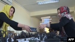 Election campaign workers prepare biometric devices in Kabul.