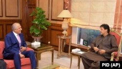 FILE: Pakistani Prime Minister Imran Khan (L) meets with U.S. envoy Zalmay Khalilzad in Islamabad.