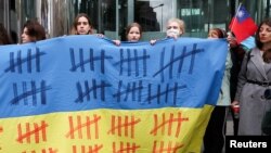 People protest to mark the third anniversary of Russia's invasion of Ukraine, in Taipei