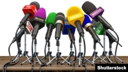 GENERIC – Press conference or interview concept. Microphones of different mass media, radio, tv and press prepared for conference meeting. 3d illustration.