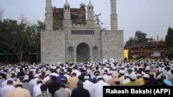 Muslims take part in Eid Al-Adha prayers in Jammu, Kashmir. 