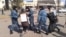 Полиция уводит жительницу Астаны Алтын Червалиеву, которая проводила пикет против сноса ее жилья. 3 апреля 2014 года.