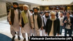 FILE: Mullah Abdul Ghani Baradar, the Taliban group's top political leader, third from left, arrived with other members of the Taliban delegation for talks in Moscow in May 28.