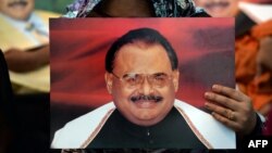Supporters of Pakistan's Muttahida Qaumi Movement (MQM)party hold photographs of party leader Altaf Hussain during a June protest in Karachi.