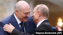 Belarusian leader Alyaksandr Lukashenka greets Russian President Vladimir Putin in Minsk in November 2017