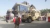FILE: An Afghan soldier stands guard at the entrance of a government compound in Farah Province.