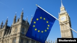 Generic – European Union flag hanging in front of Big Ben and the Houses of Parliament at Westminster Palace, London, in preparation for the Brexit EU referendum
