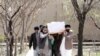 Afghan Sikh men carry a coffin of one of the victims who was killed during a March 25 attack on Sikh religious complex in Kabul.