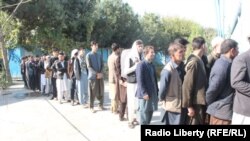 Afghan voters wait in a queue to cast their ballots in the northern Kunduz Province on October 20.