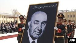 Army officers carry a portrait of former President Mohammad Daud Khan during his funeral in Kabul.